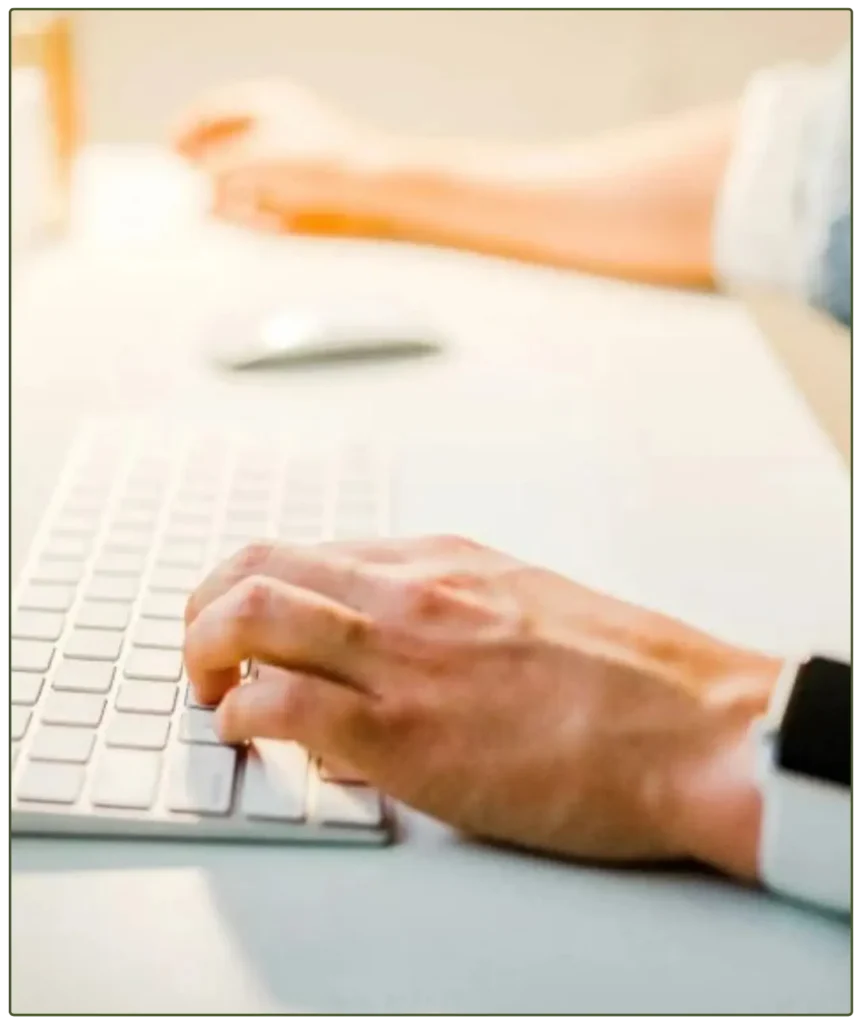 person typing on his keyboard